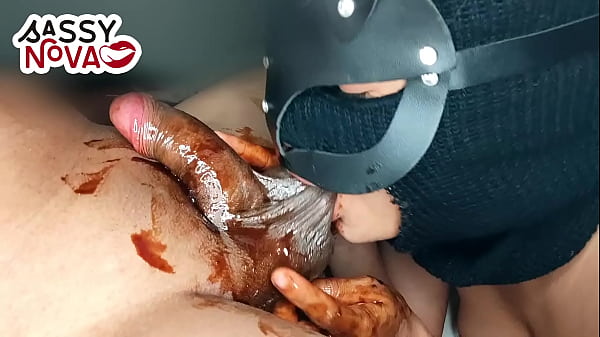 Namorada adolescente excitada chupando e lambendo bolas pretas e pau com calda de chocolate nas comemorações de Natal